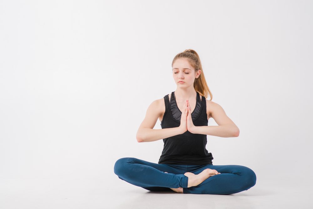 women performing ardha padmasana