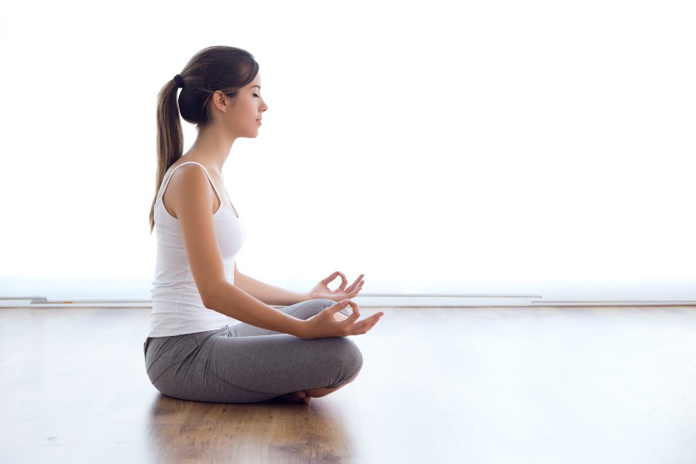 yoga student performing sukhasana
