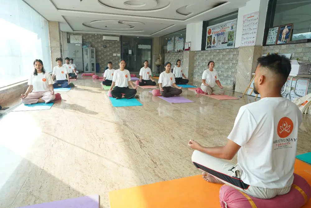 yoga teacher with students during yoga ttc