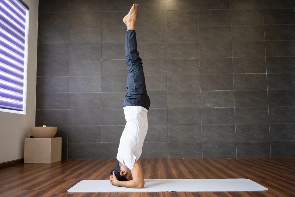 yoga student practising headstand yoga pose yoga student practising headstand yoga pose