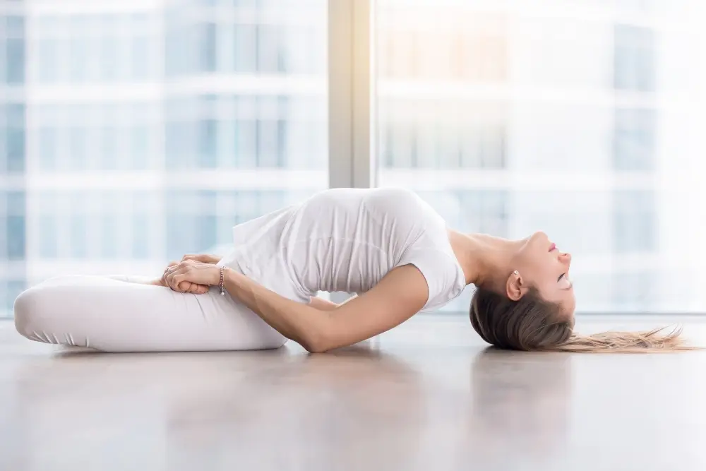 student performing matsyasana (fish pose) at mrityunjay yogpeeth
