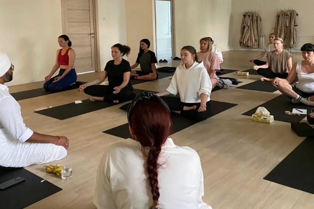 yoga students practicing guided meditation during a yoga teacher training session yoga students practicing guided meditation during a yoga teacher training session