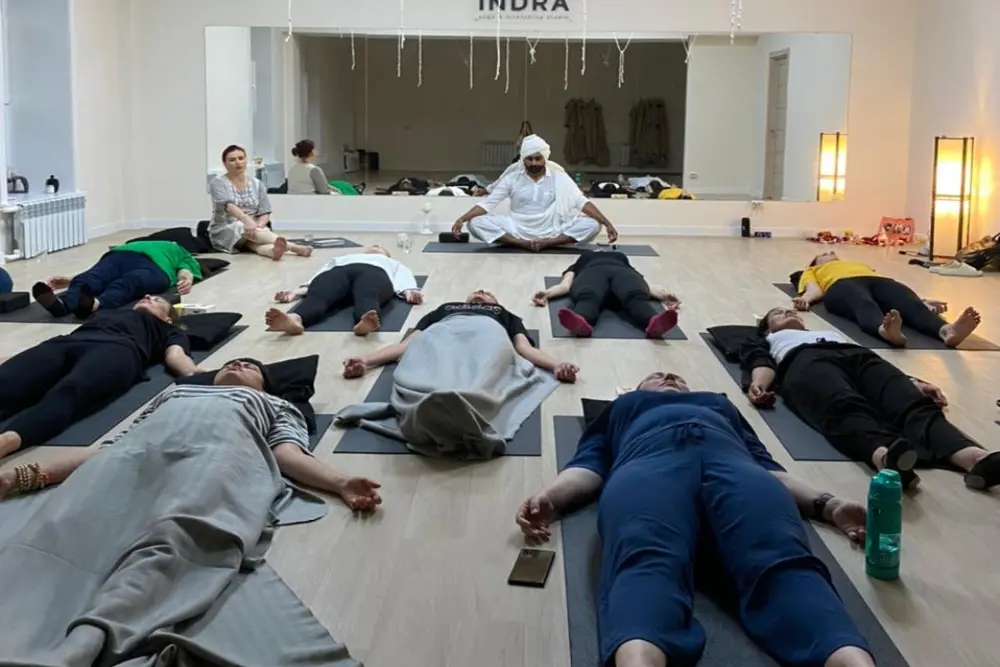 yoga teacher guiding students in performing nidra