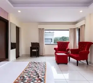 Deluxe retreat room with cozy seating for spiritual healing yoga retreat accommodation