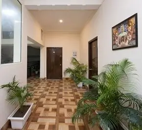 Peaceful accommodation hallway with indoor plants at a spiritual healing yoga retreat