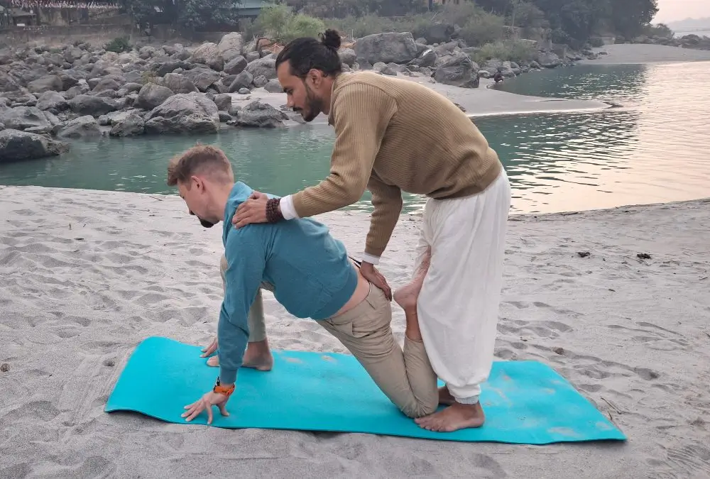 student with yoga teacher during yoga ttc