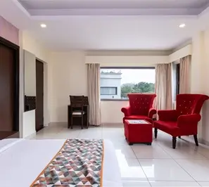 Yoga course accommodation room with seating area in Rishikesh