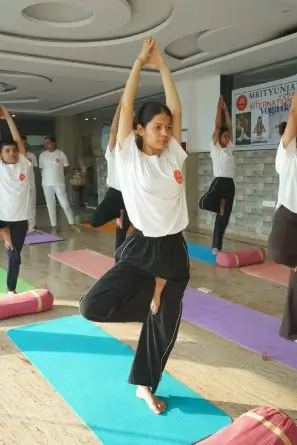yoga student performing yoga pose at mrityunjay yogpeeth