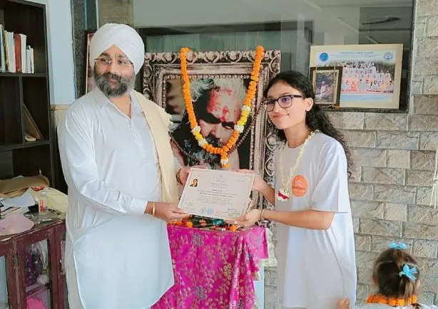 yoga ttc student receiving certificate